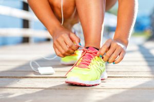 Running shoes - woman tying shoe laces
