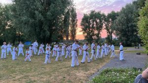 Gruppenbild: Karatekas trainieren auf Wiese